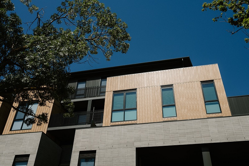 Image of apartment with windows, balcony  and trees