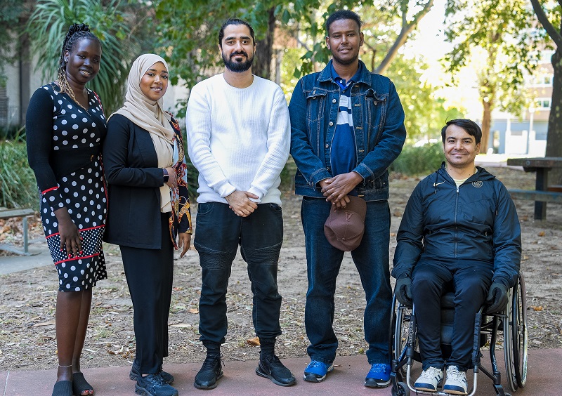 Images of Yarra employment program trainees standing and one on his wheelchair and everyone are smiling