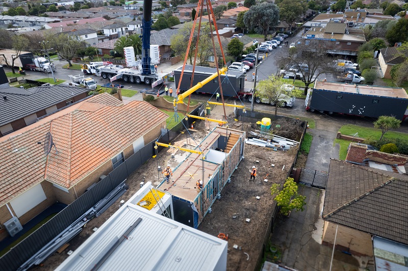 Image of construction site where workers are working to assemble the units and built a new homes for young people with a disability in Melbourne’s north 