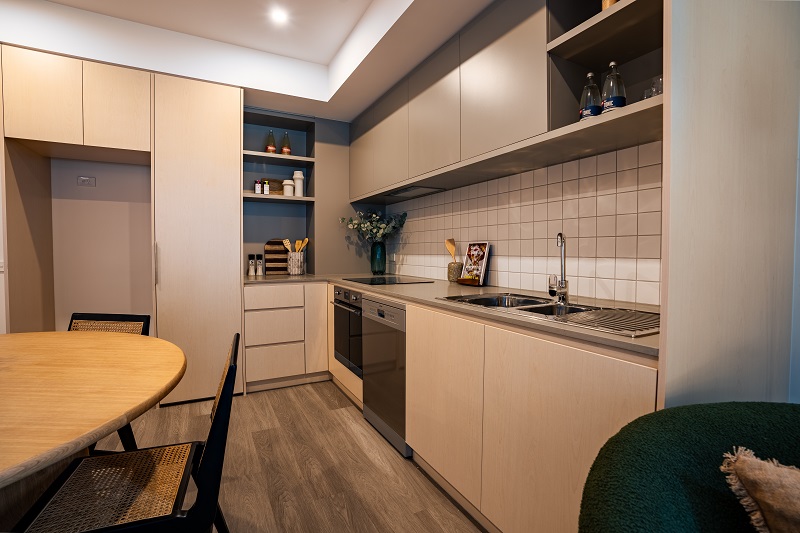 Image of Kitchen area with electric cook top, dishwasher, dining area and ample storage.