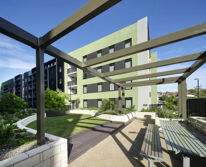 Pergola with a new apartment building in the background