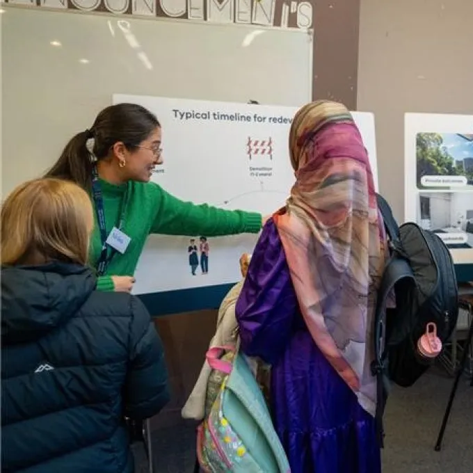 Image of staff and community at the information centre attending the session to find more about the project